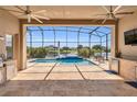 Enjoy outdoor living with a screened-in lanai, pool, and outdoor kitchen at 13232 Alderley Dr, Orlando, FL 32832