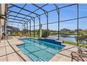 Relax in your backyard oasis with a sparkling pool, spa and tranquil water view at 13232 Alderley Dr, Orlando, FL 32832