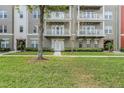 Beautiful building entrance showcasing meticulous landscaping and pedestrian walkway at 1400 Celebration Ave # 203, Celebration, FL 34747