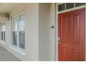 Inviting entryway features a bright red door and sidelight windows at 1400 Celebration Ave # 203, Celebration, FL 34747