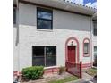 Condominium exterior with well-maintained landscaping, red accents, and neutral exterior at 1635 Little Falls Cir, Orlando, FL 32807