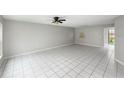 Spacious living room with tiled floors and ample natural light from adjacent rooms at 1635 Little Falls Cir, Orlando, FL 32807