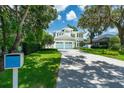 Beautiful home with mature trees, lush lawn, and a long driveway leading to a charming residence at 1820 Glencoe Rd, Winter Park, FL 32789