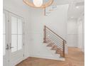 Inviting foyer features a modern staircase, wood floors, and a bright, open feel at 1820 Glencoe Rd, Winter Park, FL 32789