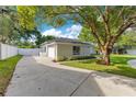 The house features an attached garage and a long driveway, all surrounded by mature trees and well-maintained landscaping at 2024 Flaming Arrow Ct, Fern Park, FL 32730