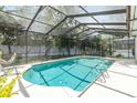 Inviting screened-in pool with sun deck and ladder, creating a private outdoor oasis for relaxation and recreation at 205 Stevenage Dr, Longwood, FL 32779