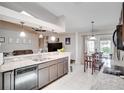 Open kitchen with stainless steel dishwasher, granite countertops and a cozy breakfast nook at 2406 Sweetwater Blvd, St Cloud, FL 34772