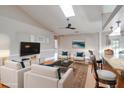 Inviting living room with plush seating, modern decor, and a seamless flow to the kitchen at 2406 Sweetwater Blvd, St Cloud, FL 34772