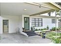 Inviting covered entrance featuring a quaint front door with a decorative wreath and a well-maintained landscape at 3519 Amigos Ave, Orlando, FL 32808