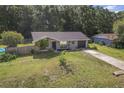 Charming single-story home featuring a well-maintained lawn and a long driveway leading to an attached garage at 3565 Sw Idlewild St, Dunnellon, FL 34431