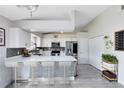 Bright kitchen featuring white cabinets, stainless steel appliances, and an island with seating at 4478 Yachtmans Ct, Orlando, FL 32812