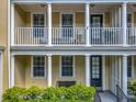 Welcoming front porch and second-story balcony with white columns and outdoor seating at 4584 Virginia Dr, Orlando, FL 32814