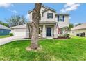 Beautiful two-story home featuring an inviting front porch, well-maintained lawn, and tasteful landscaping at 486 Shirley Dr, Apopka, FL 32712