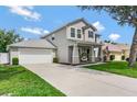 Well-maintained two-story home with attached garage, long driveway, inviting front porch, and lush green lawn at 486 Shirley Dr, Apopka, FL 32712