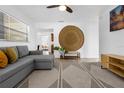 Cozy living room with modern decor, a comfortable gray sofa, and textured rug at 531 Wigman Dr, Eatonville, FL 32751