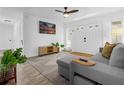 Bright living room with white walls, tile flooring, and stylish furnishings at 531 Wigman Dr, Eatonville, FL 32751