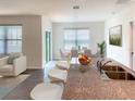 Spacious kitchen area with island seating, modern appliances, and a bright dining area at 613 Hickory Course Loop, Ocala, FL 34472