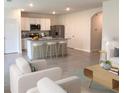 Open-concept living space with tile flooring, modern furnishings, and a bright, airy atmosphere at 613 Hickory Course Loop, Ocala, FL 34472