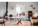 Cozy living room with fireplace and stylish mid century modern furniture at 627 N Cherokee Ave, Deland, FL 32724