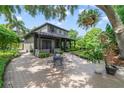 Charming brick patio featuring an outdoor dining set, surrounded by lush landscaping and greenery at 640 S Lake Formosa Dr, Orlando, FL 32803