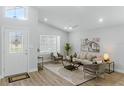 Bright and airy living room boasts wood floors, neutral-toned furniture, and stylish decor at 841 Wesson Ct, Casselberry, FL 32707
