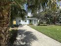 Charming single-story home with well-maintained landscaping and a private driveway at 910 Flamingo Dr, Leesburg, FL 34748