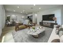 Bright, open-concept living room featuring modern furnishings and hardwood flooring at 910 Flamingo Dr, Leesburg, FL 34748