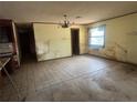 Dining room with tiled floors featuring a chandelier fixture ready to be revitalized at 4250 Lake Ave, Kissimmee, FL 34746