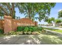 Community entrance sign for Monterey Oaks featuring a brick wall with landscaping and green foliage at 100 Monterey Oaks Dr, Sanford, FL 32771