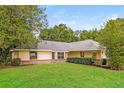 Charming single story home with a well-manicured lawn at 10448 Sw 74Th Ct, Ocala, FL 34476