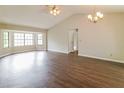 Spacious living room with hardwood floors, lots of natural light, ceiling fan, and chandelier at 10448 Sw 74Th Ct, Ocala, FL 34476
