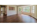 Bright living room featuring hardwood floors and large windows providing ample natural light at 10448 Sw 74Th Ct, Ocala, FL 34476