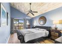 Bedroom featuring a vaulted ceiling, fan, and balcony access for natural light at 1051 S Highland St # 7D, Mount Dora, FL 32757