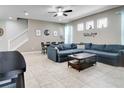 Spacious living room featuring tile floors, a ceiling fan, and plenty of natural light at 14460 Orchard Hills Blvd, Winter Garden, FL 34787