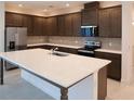Modern kitchen featuring a large quartz island, stainless steel appliances, and stylish cabinets at 14568 Crestavista Ave, Clermont, FL 34714