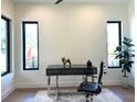 Bright home office featuring hardwood floors, large windows, a modern desk, and stylish decor at 1733 Harmon Ave, Winter Park, FL 32789