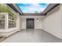 Inviting covered entry featuring double doors, textured walls, tiled floors, and natural light at 1921 Heathwood Dr, Winter Park, FL 32792
