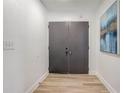 Bright entryway featuring double doors, hardwood flooring, and modern decor at 1921 Heathwood Dr, Winter Park, FL 32792