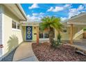 Charming front entrance showcasing a well-designed pathway leading to a vibrant blue front door at 1926 Natalen Rd, Winter Park, FL 32792