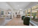 Bright living room with modern décor, light wood floors, and seamless transition to the outdoor space at 1926 Natalen Rd, Winter Park, FL 32792