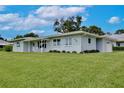 Lovely single-story home with a lush green lawn, offering a serene and inviting curb appeal at 216 N Riverside Dr, Edgewater, FL 32132