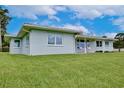 Side view of a single-story house showcasing the well-maintained lawn and exterior features at 216 N Riverside Dr, Edgewater, FL 32132
