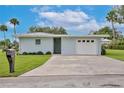 Quaint single-story house with a garage and green lawn, offering comfort and practicality at 216 N Riverside Dr, Edgewater, FL 32132