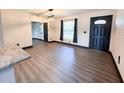 Bright dining room with hardwood floors, a modern light fixture, and access to other rooms at 2342 Alice Ave, Eustis, FL 32726