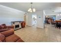 Cozy living room with tile flooring, a decorative fireplace, and a view of the adjacent dining room at 2728 Hertha Ave, Orlando, FL 32826