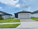 Cozy single-story house with manicured lawn, brick driveway, and close to neighbors at 2824 Neverland Dr, New Smyrna Beach, FL 32168