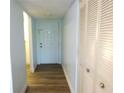 Hallway with white walls and a white door, wood-look floors and a large closet at 2864 N Powers Drive # 156, Orlando, FL 32818