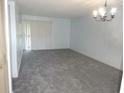 Spacious living room with new carpet and natural light fixture at 2864 N Powers Drive # 156, Orlando, FL 32818