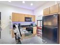 Efficient kitchen with a black appliance package and granite countertops at 3010 Secret Lake Dr, Kissimmee, FL 34747