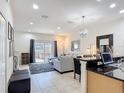 Open-concept space with modern furnishings and a sliding glass door to the patio at 3010 Secret Lake Dr, Kissimmee, FL 34747